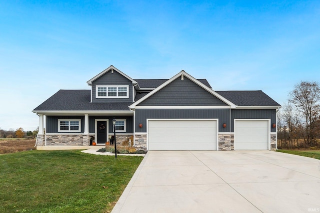 craftsman-style house featuring a front lawn and a garage