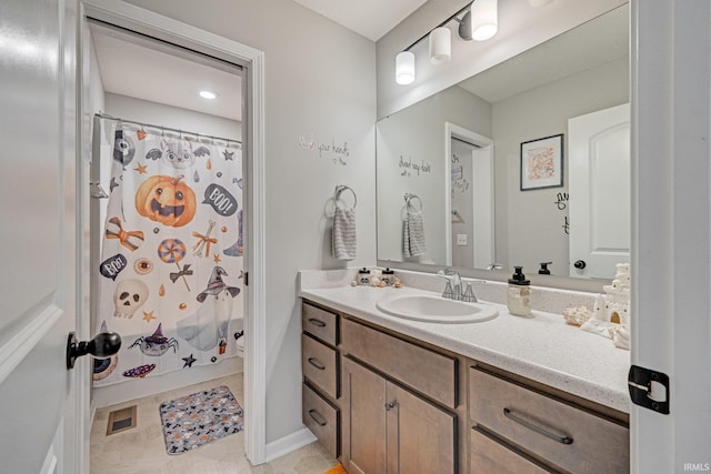 bathroom with vanity, shower / tub combo with curtain, and tile patterned floors