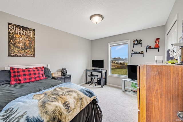 carpeted bedroom featuring a textured ceiling