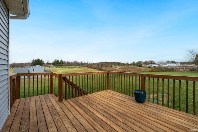 wooden terrace featuring a yard