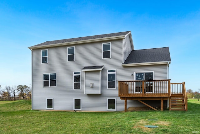 rear view of house featuring a deck and a lawn