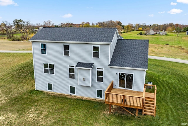 back of house featuring a deck and a lawn