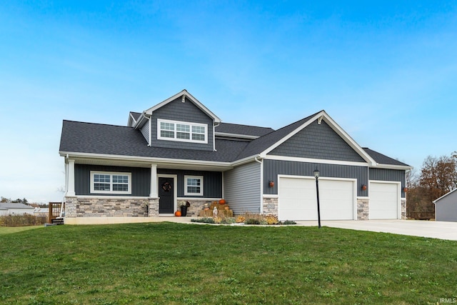 craftsman inspired home featuring a garage and a front lawn