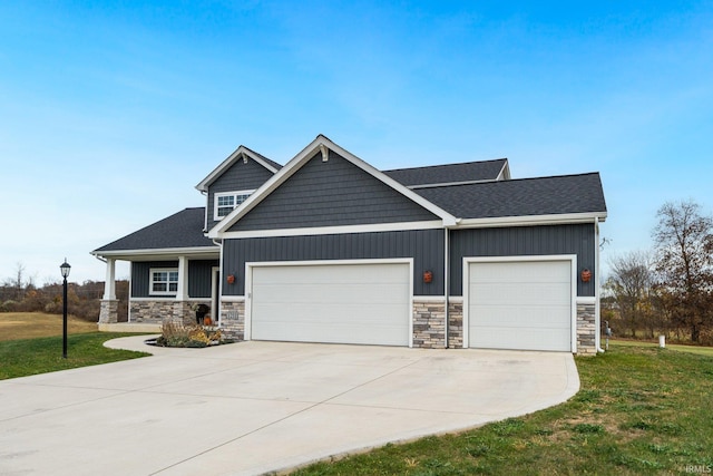 craftsman inspired home featuring a front yard and a garage