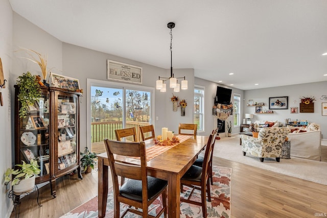 dining room featuring a notable chandelier and light wood-type flooring