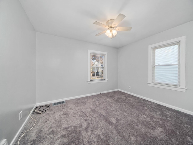 spare room featuring carpet flooring and ceiling fan