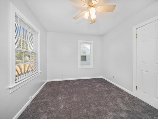 carpeted empty room featuring ceiling fan