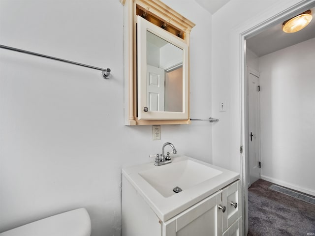 bathroom featuring toilet and vanity