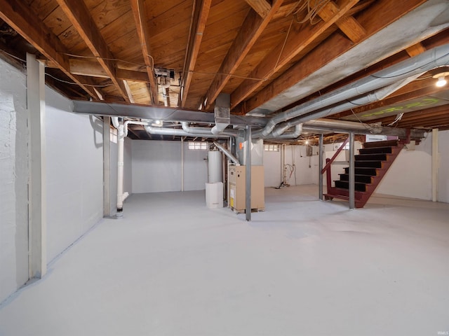 basement featuring heating unit and gas water heater