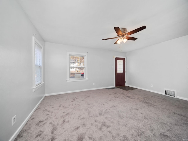 carpeted empty room featuring ceiling fan