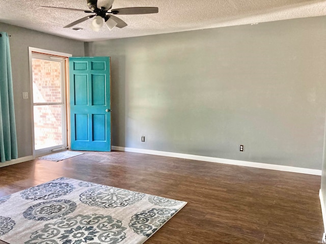 unfurnished room featuring dark hardwood / wood-style floors, a textured ceiling, and ceiling fan