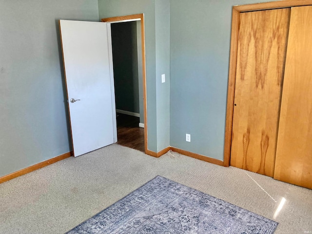 unfurnished bedroom with carpet floors and a closet