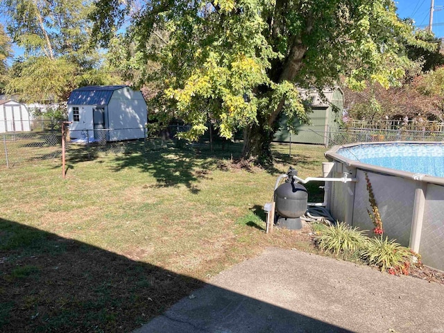 view of yard featuring a fenced in pool and a storage shed