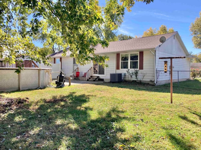 exterior space featuring cooling unit and a lawn