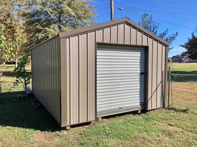 view of outbuilding featuring a lawn