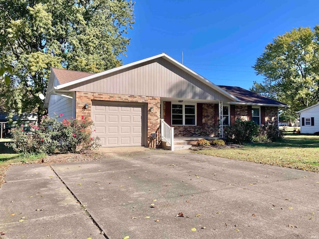 single story home featuring covered porch, a front yard, and a garage