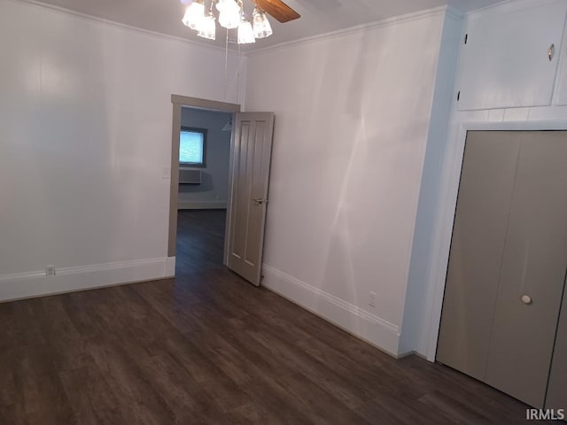 unfurnished room featuring ceiling fan, dark hardwood / wood-style flooring, and crown molding