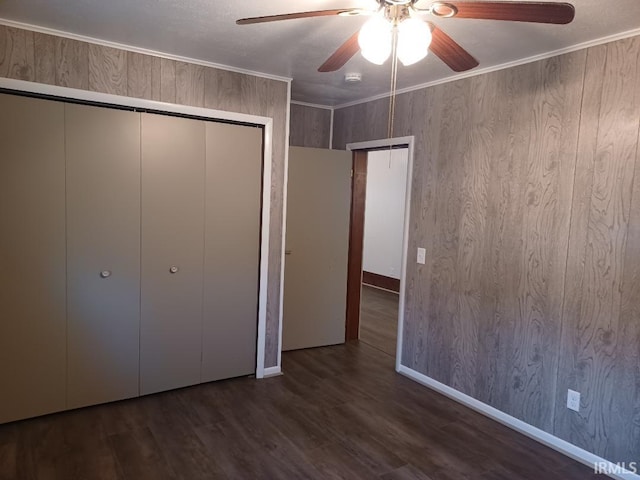 unfurnished bedroom with ceiling fan, dark hardwood / wood-style flooring, and ornamental molding