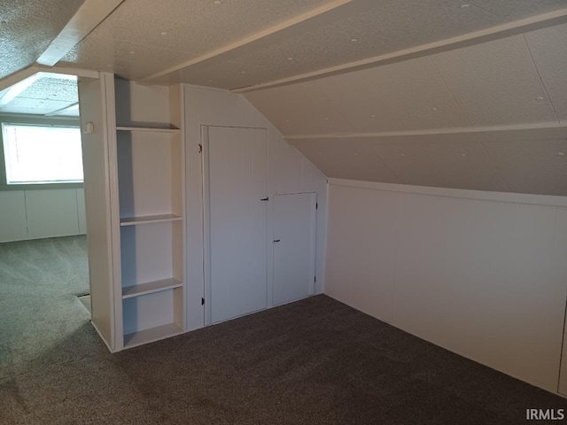 bonus room featuring carpet flooring, a textured ceiling, and vaulted ceiling