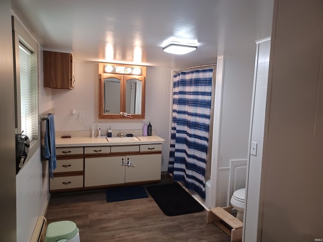 bathroom with vanity, toilet, wood-type flooring, and a baseboard radiator