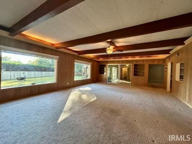 spare room featuring ceiling fan, carpet, and a textured ceiling