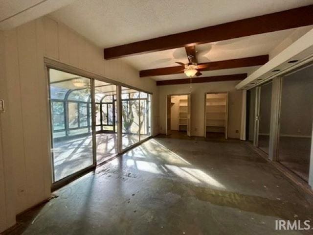 spare room featuring beam ceiling and ceiling fan