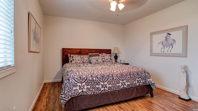 bedroom featuring hardwood / wood-style floors and ceiling fan