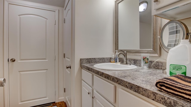 bathroom with vanity and hardwood / wood-style flooring