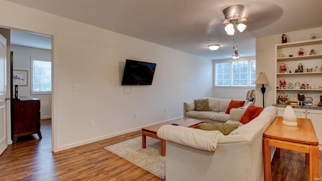 living room with ceiling fan and hardwood / wood-style flooring