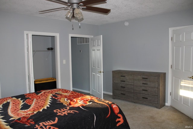 carpeted bedroom with a textured ceiling and ceiling fan