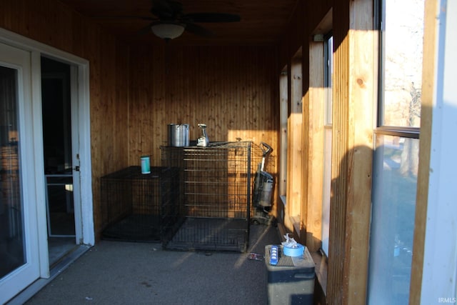 exterior space featuring carpet flooring and wood walls