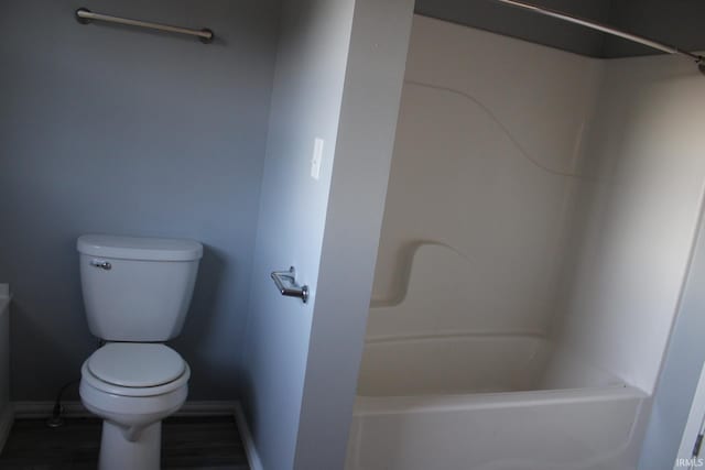 bathroom featuring toilet and shower / bath combination