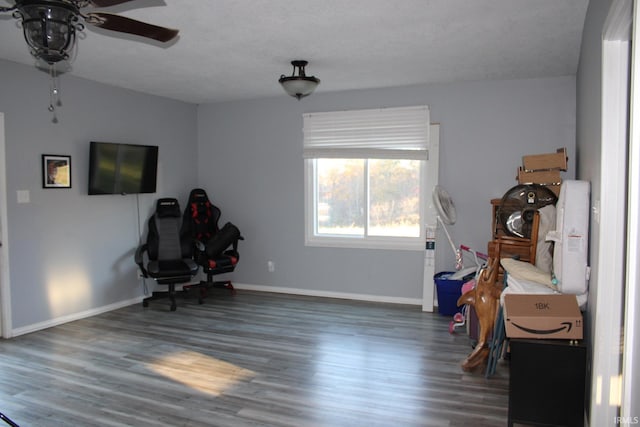 interior space featuring ceiling fan, a textured ceiling, and dark hardwood / wood-style floors