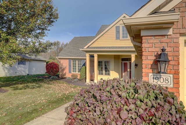 view of exterior entry featuring a yard