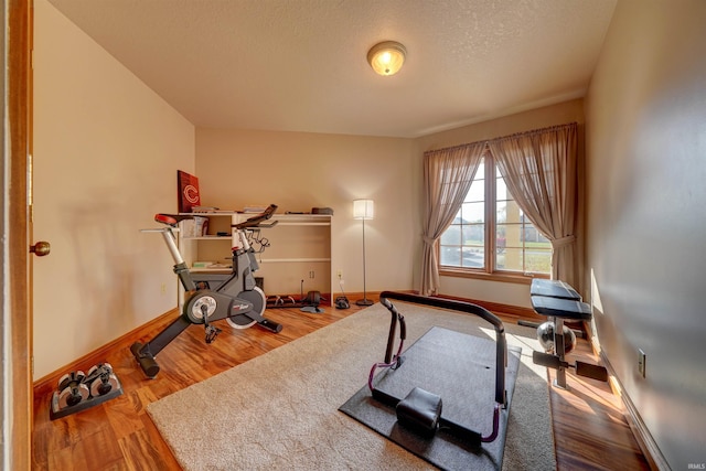 workout room with a textured ceiling and hardwood / wood-style flooring