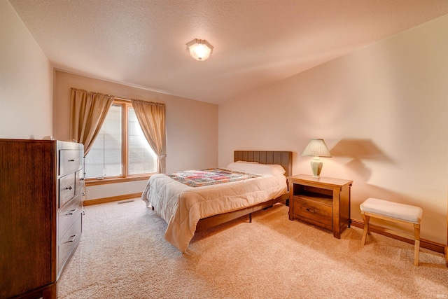 carpeted bedroom featuring a textured ceiling