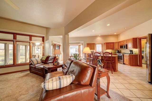 living room with a textured ceiling and light tile patterned floors