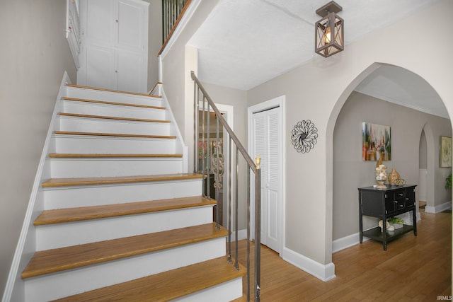 stairway with hardwood / wood-style flooring