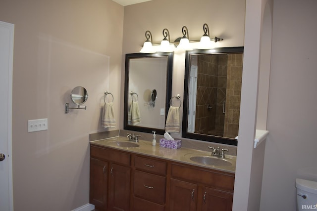 bathroom featuring a sink, toilet, and double vanity