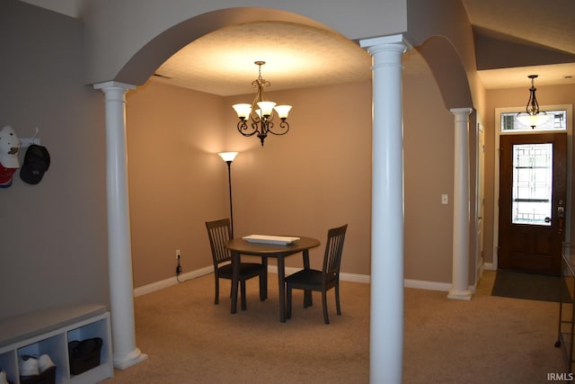 dining room featuring arched walkways, baseboards, carpet, ornate columns, and a notable chandelier