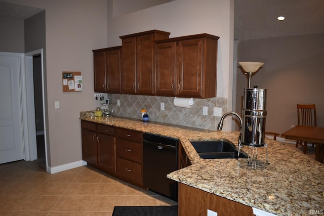 kitchen featuring light tile patterned floors, light stone counters, a sink, backsplash, and dishwasher