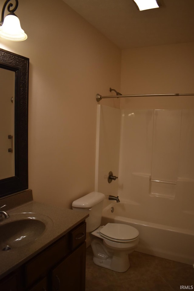 full bathroom featuring washtub / shower combination, vanity, tile patterned flooring, and toilet