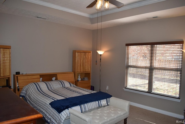 carpeted bedroom featuring ornamental molding, a raised ceiling, visible vents, and baseboards