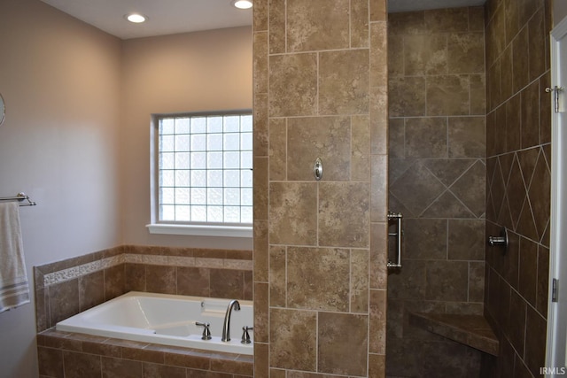 bathroom featuring a garden tub, tiled shower, and recessed lighting