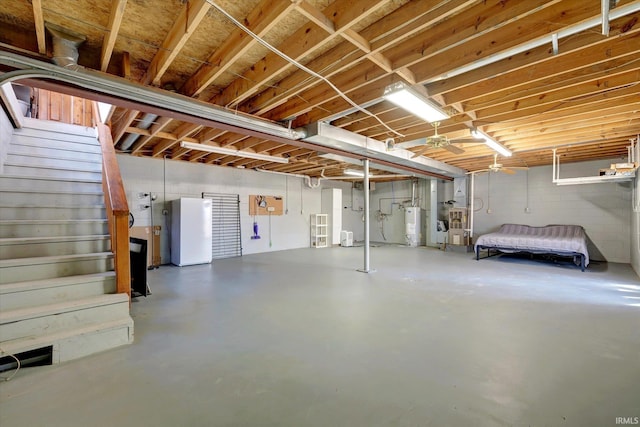 basement with white fridge and water heater