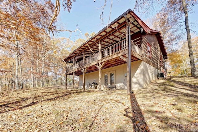 rear view of house with french doors and a deck