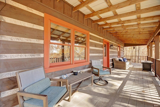 sunroom with vaulted ceiling with beams