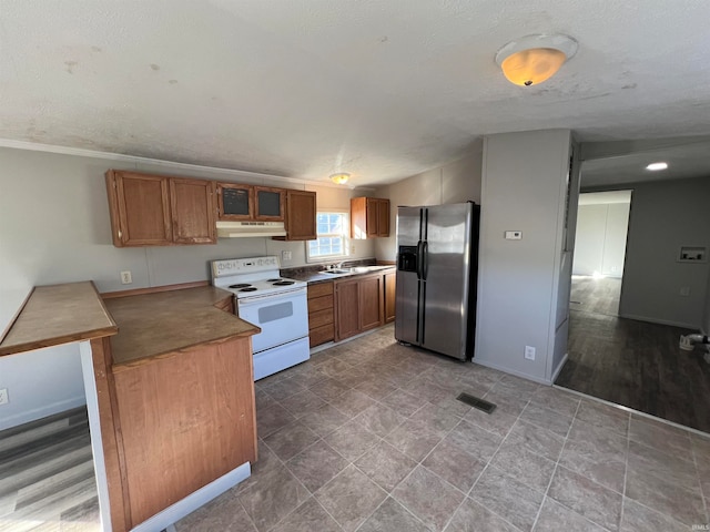 kitchen with electric range, stainless steel refrigerator with ice dispenser, a textured ceiling, and light hardwood / wood-style floors