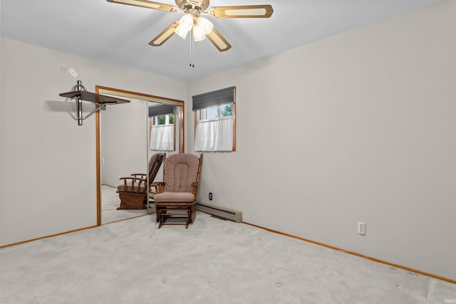 unfurnished room with ceiling fan, light colored carpet, and a baseboard heating unit