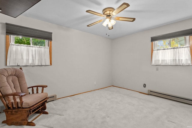 living area featuring baseboard heating, ceiling fan, and light carpet